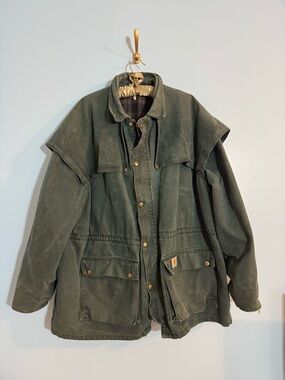 Classic vintage Carhartt CW043 chore jacket in hunter green duck canvas.